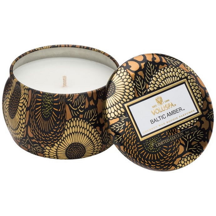 A coconut wax candle in a decorative japanese inspired tin baltic amber voluspa