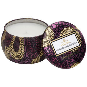 A coconut wax candle in a decorative japanese inspired tin santiago huckleberry voluspa
